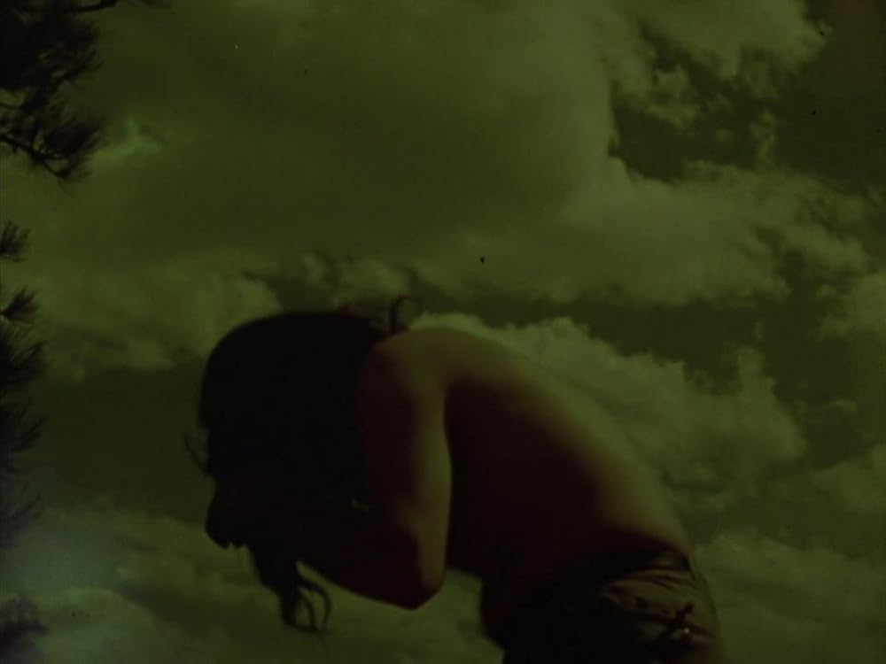 The climber’s body folded against the mountain in Stan Brakhage’s Dog Star Man.