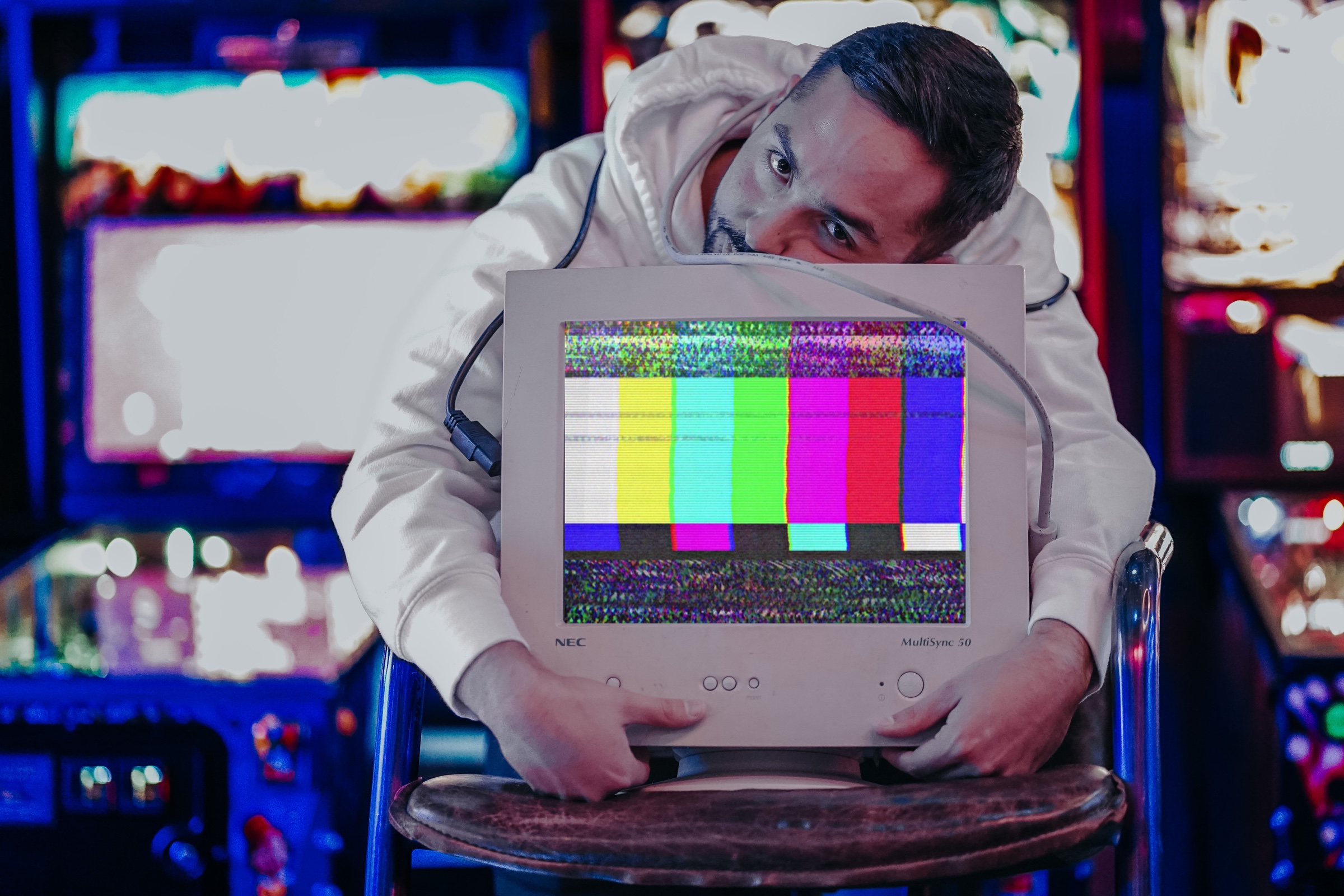 Ryan Chang holding a CRT monitor displaying color bars.