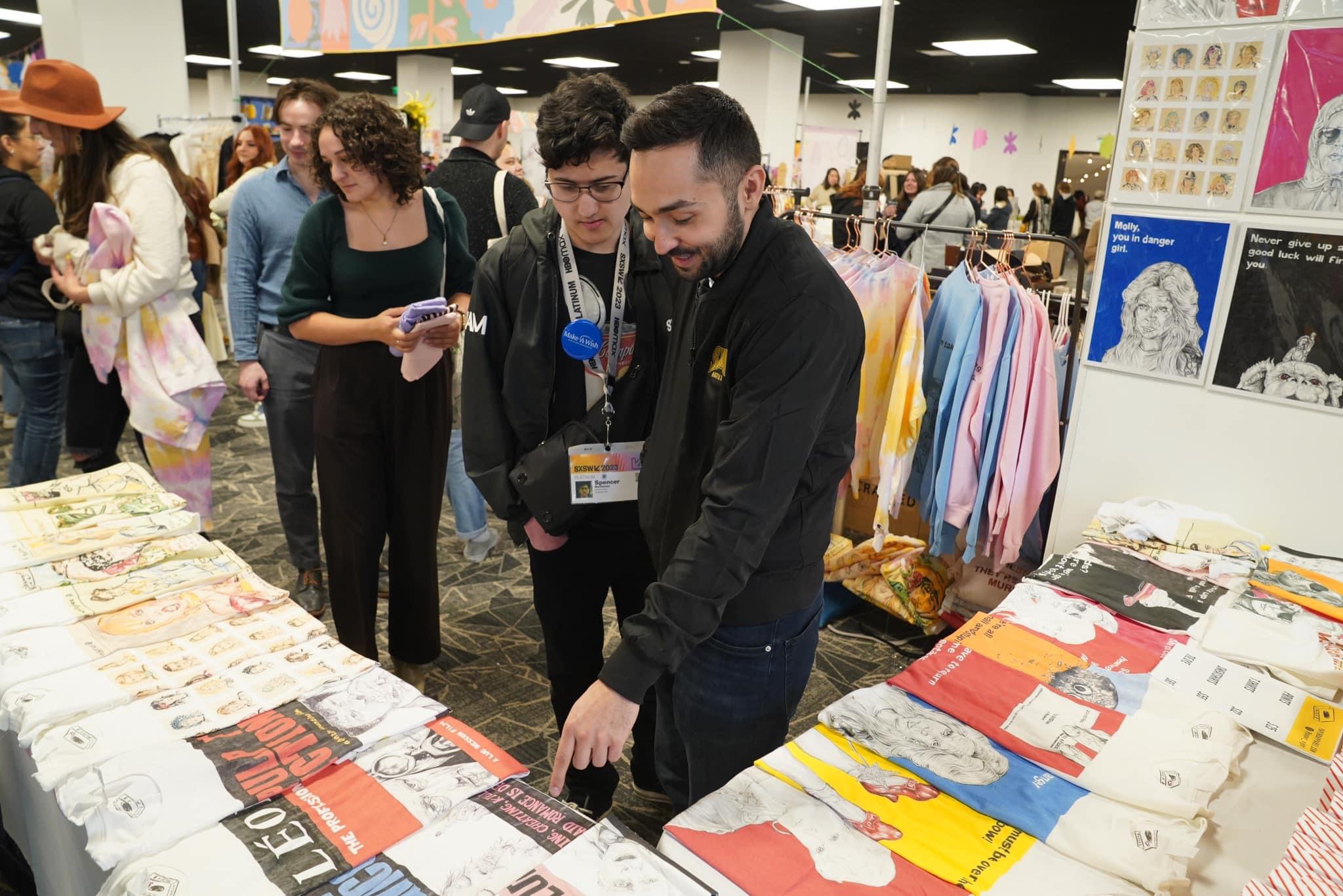 Ryan Chang browsing artists’ work at SXSW.