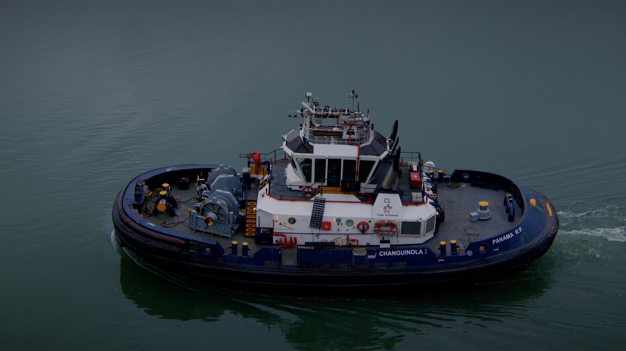 The Changuinola I tugboat viewed from above on blue water.