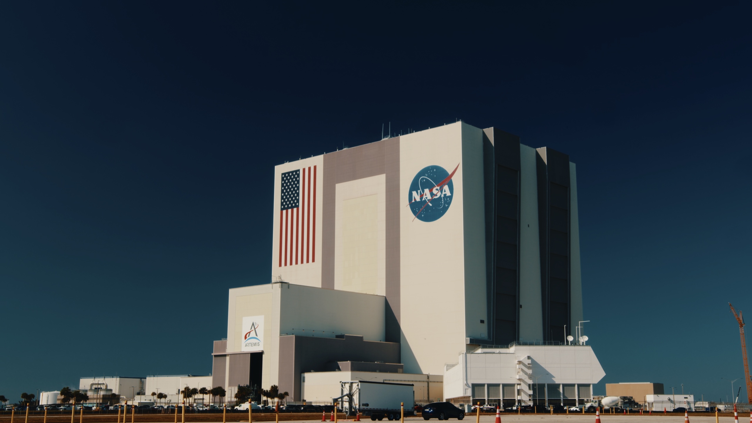 NASA's Vehicle Assembly Building beneath a deep blue sky.