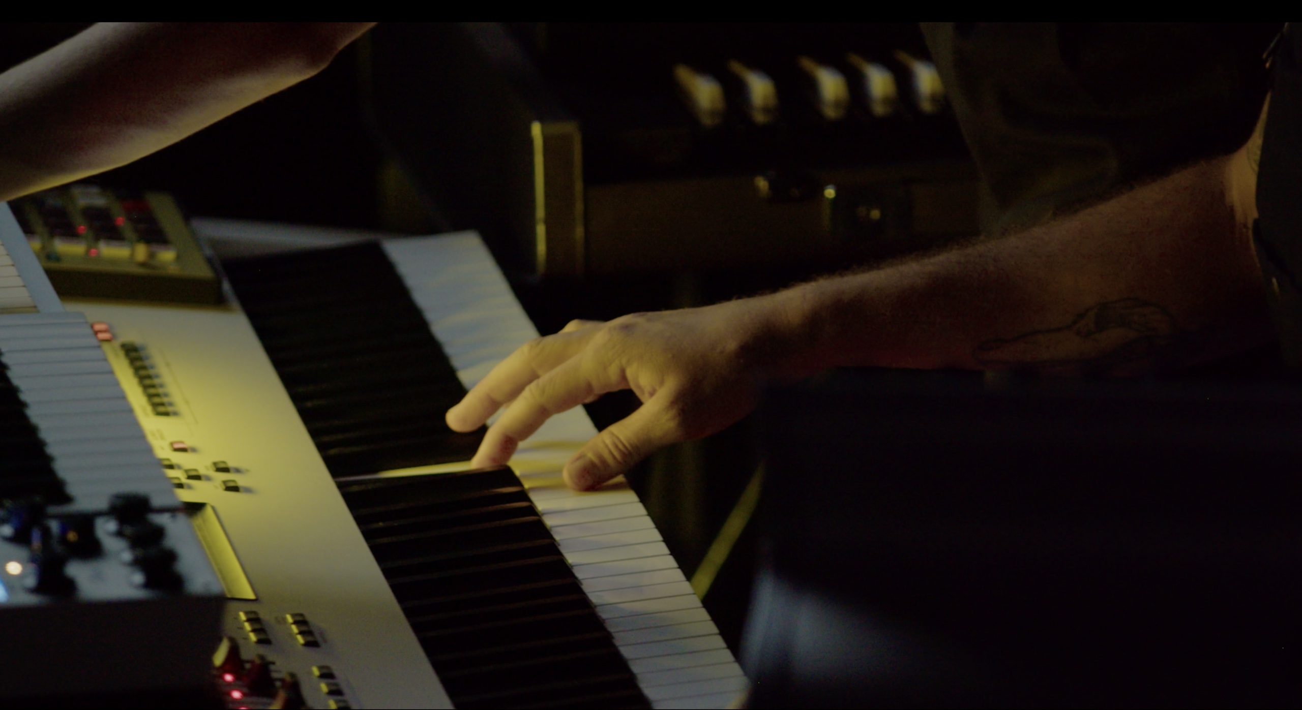 A musician's hands playing an electronic keyboard.