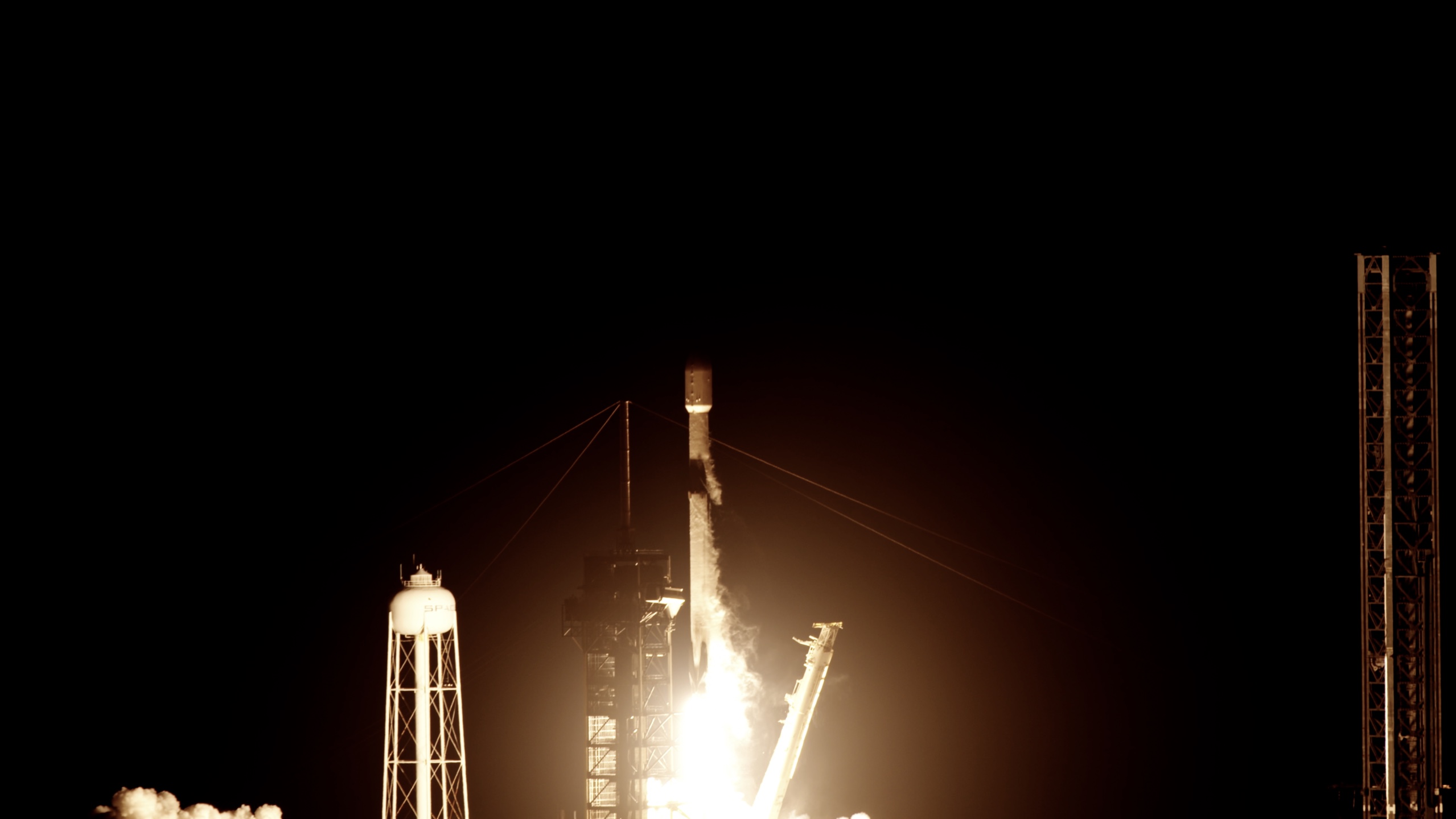 A rocket lifting off at night from Kennedy Space Center.